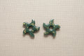 Étoile verte et feuille d'or